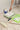 Paint roller, The Repaint Tray, and paint can on a surface with a person painting.
